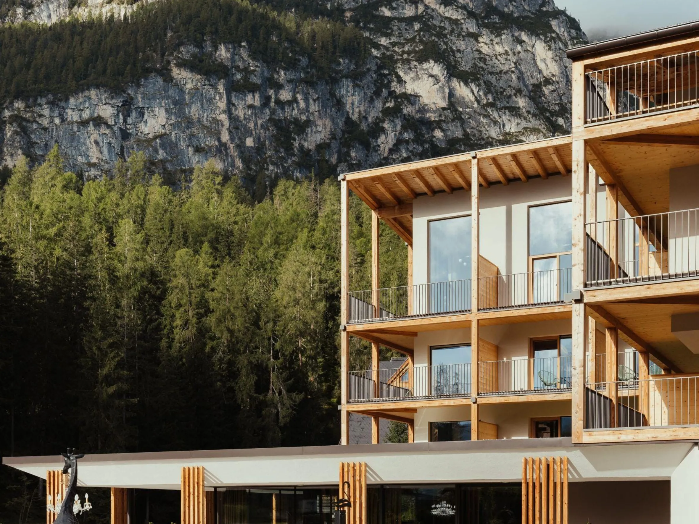 Hotel Lech da Sompunt in Alta Badia, with the Gardenacia forest end peaks in the background.